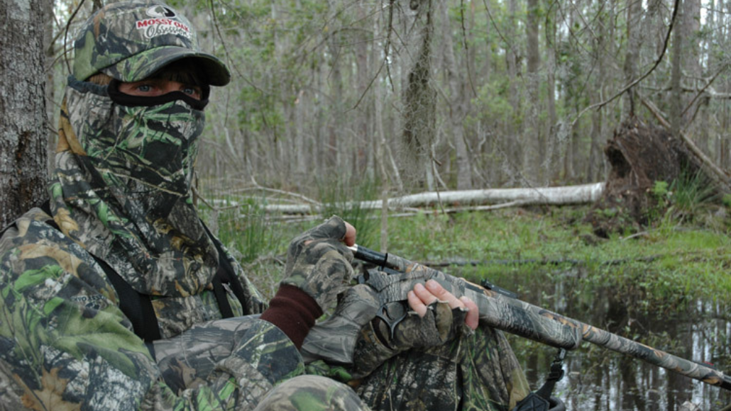 Turkey hunter in full camo in the field wild turkey hunting