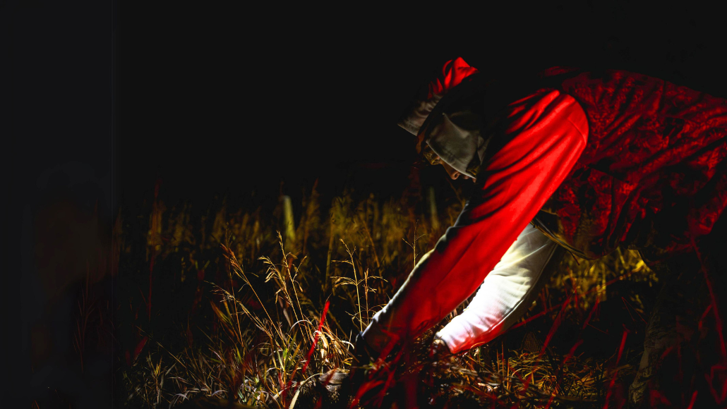 Hunter wearing headlamp in the field while waterfowl hunting