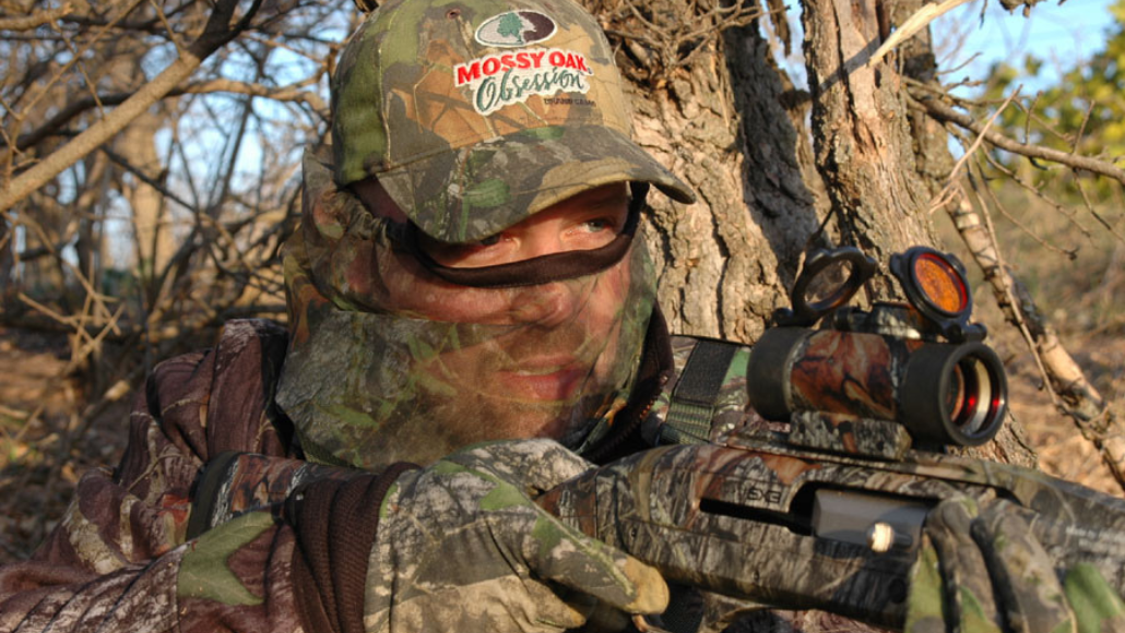 Female turkey hunter with shotgun, turkey locked in