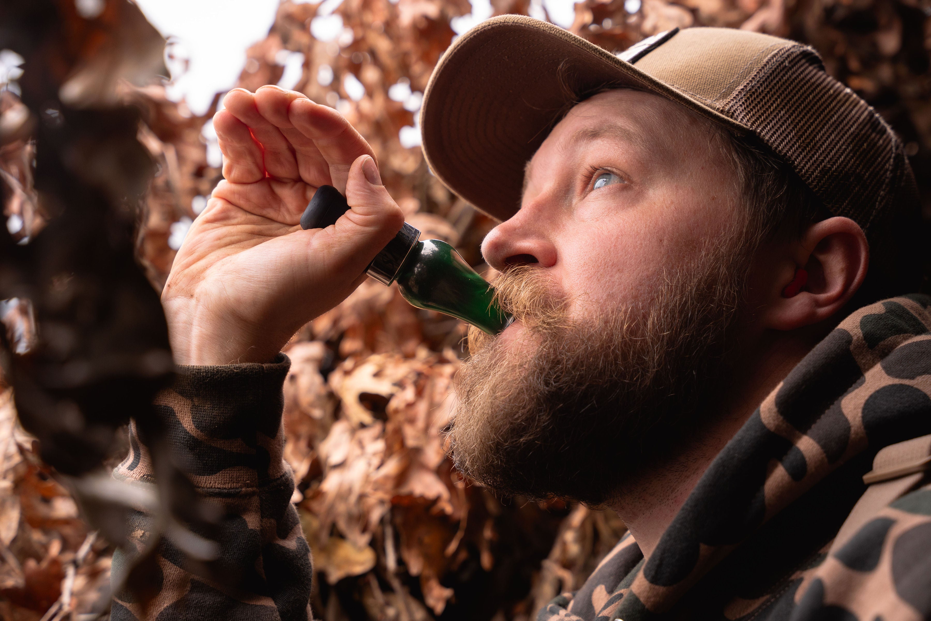 Close up of hunter using a call