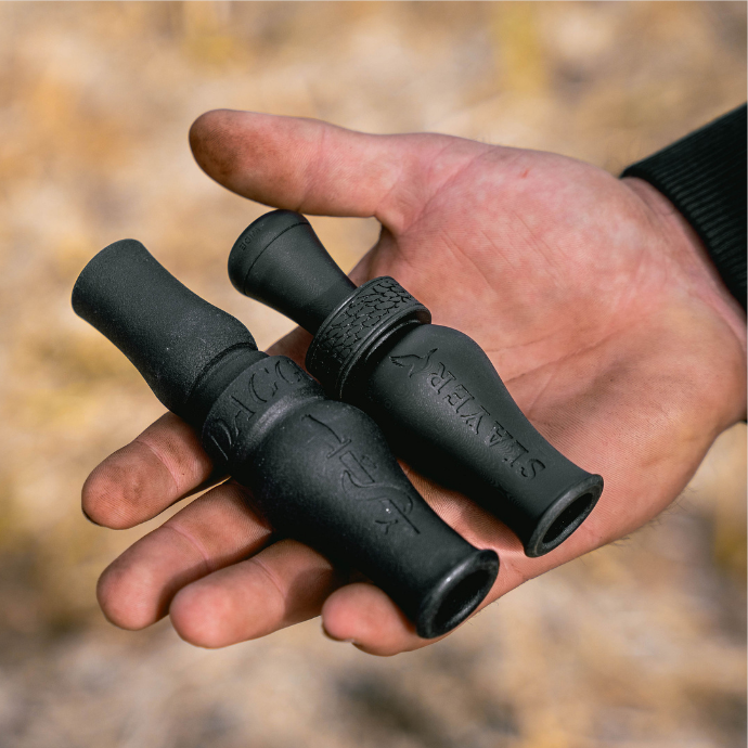 Beginner's waterfowl combo pack show with Slayer's Dagger goose call and Mallard Reaper duck call, both shown in hunter's hand
