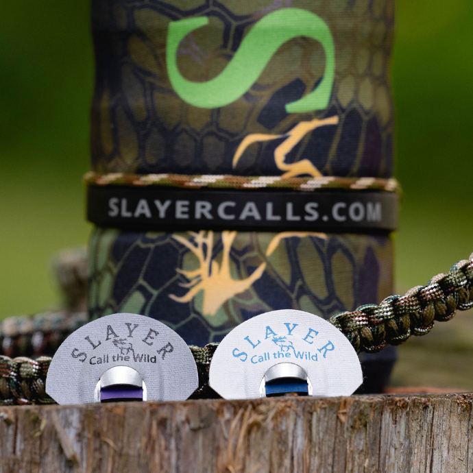 Slayer rubber bugle band shown around the base of the ArchAngel bugle tube. Clearwater Northfork and Maniac elk reeds are positioned in front of the bugle tube.