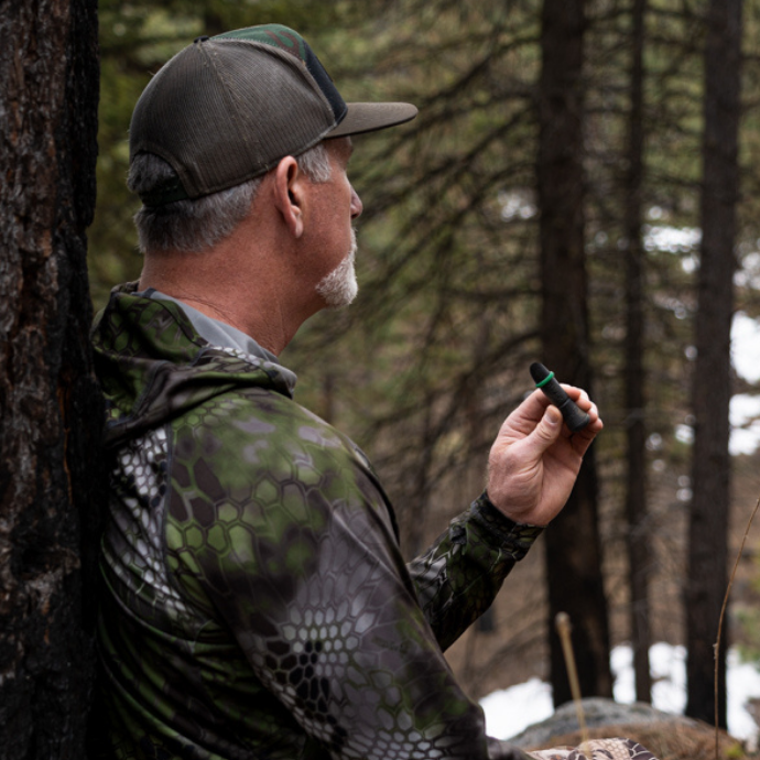 Elk hunter in the field using the external cow call by Slayer Calls.