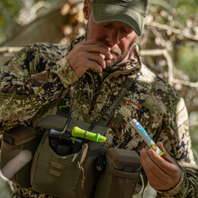 Elk hunter in the field with Slayer Calls' external calf and cow calls shown on a paracord strap around his neck