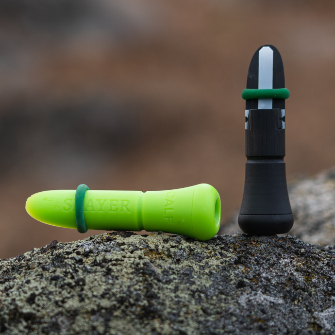 Close up of the External calf and cow calls by Slayer Calls shown on rock in the field