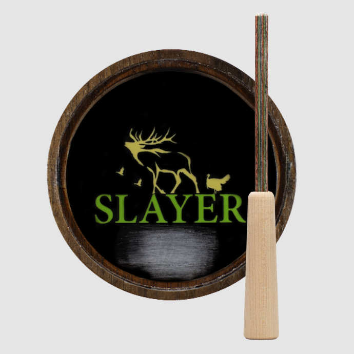 Wood and black crystal faced turkey pot call with green and gold Slayer logo.