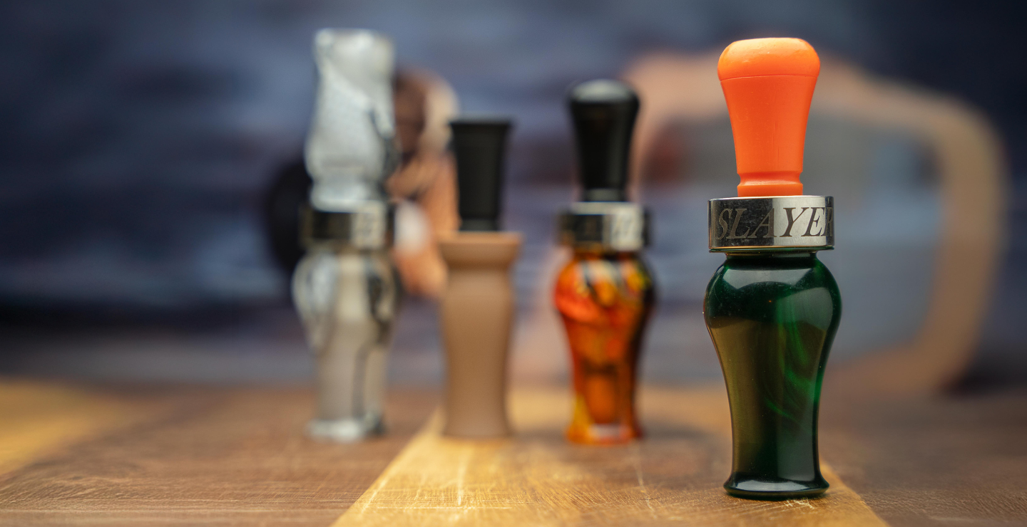 A collage of waterfowl calls — 3 are blurred while the DUBAR duck call is in full focus.