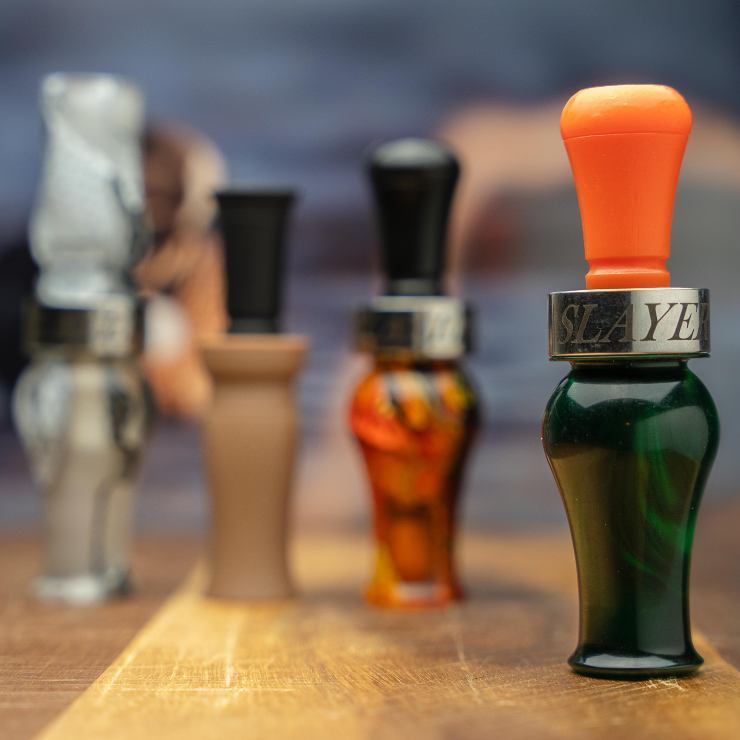 A collage of duck calls — 3 are blurred while the DUBAR duck call is in full focus.