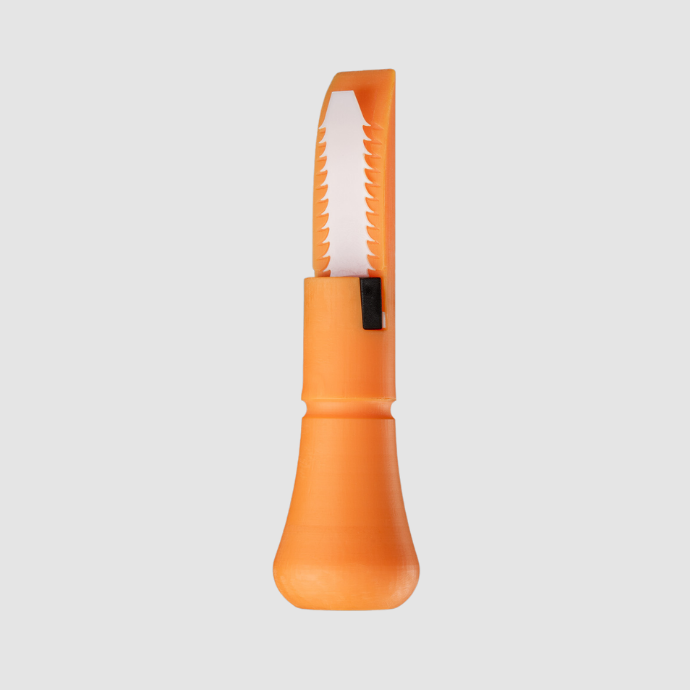 Close-up of the Slayer DUBAR duck call soundboard in orange, featuring a white, freeze-resistant single reed with tooth-like edge design for optimal tone and airflow control.