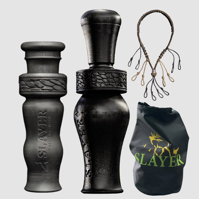 Black duck call with 'Slayer' branding, a dry bag, a duck whistle, and a waterfowl lanyard on a light gray background.