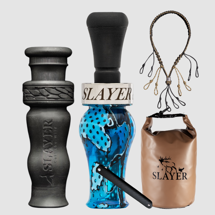 Slayer Calls duck call and duck whistle collection with Slayer's DUBAR Slayer duck call in blue, 4-in-1 duck whistle, lanyard, field dressing tool, and dry bag featuring SLAYER logo.