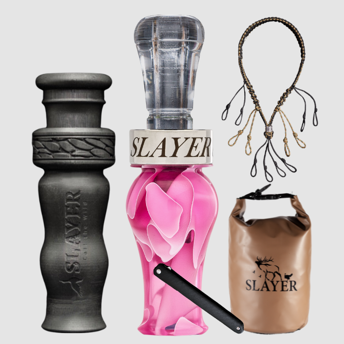 Collection of Slayer duck calls, lanyard and field bag on a light grey background