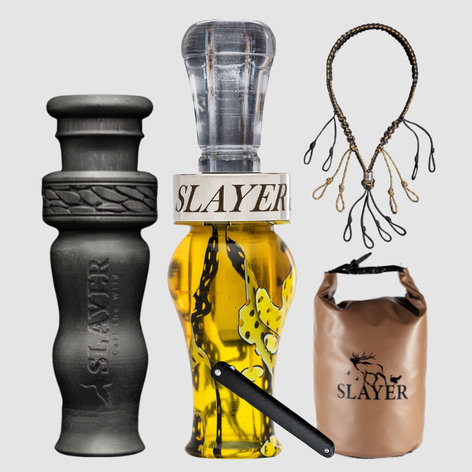 Slayer Calls duck call and duck whistle bundle with Slayer's double reed Drake Slayer duck call in yellowjacket mesh, 4-in-1 duck whistle, lanyard, field dressing tool, and dry bag featuring SLAYER logo.