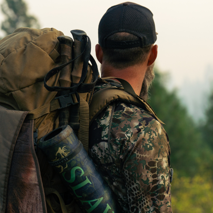 Close-up of elk hunter in camo with the Archangel bugle tube visible in his pack.