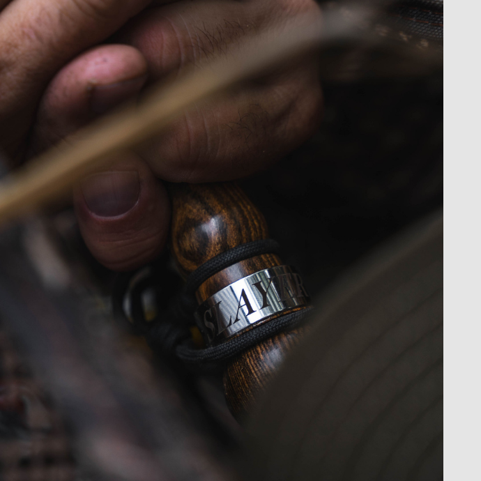 Close-up of a hunter gripping the Slayer Axe goose call in a rich wood finish — premium craftsmanship and realism for calling in honkers during the season.
