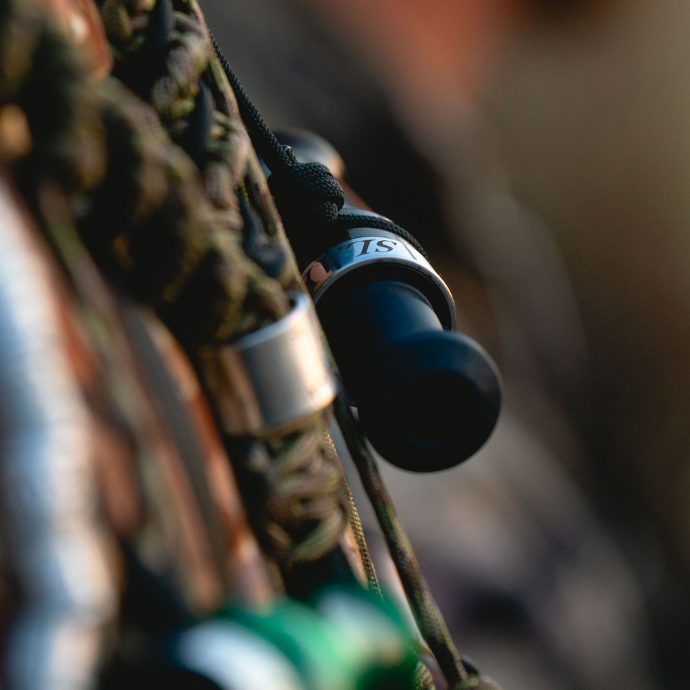 Close-up of a Slayer duck call hanging from a braided paracord lanyard — field-ready setup for waterfowl hunters demanding premium sound and quick access in the blind.