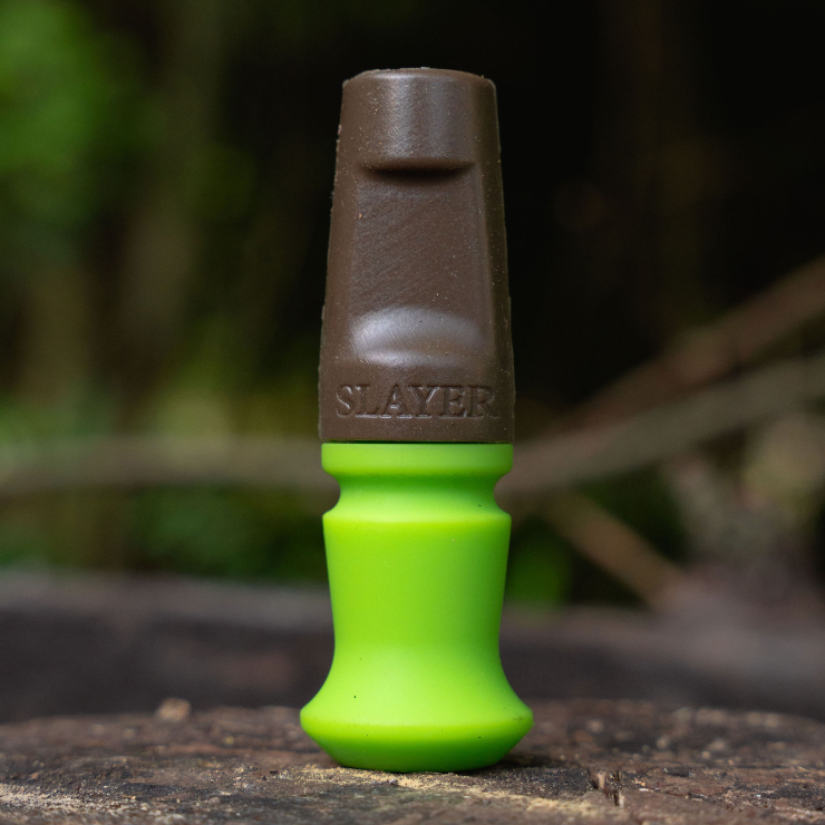 The Harem hands free elk call, bite call from Slayer Calls pictured in the elk woods in brown and Slayer green