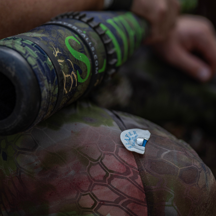 Close up image of elk hunter showing white, Maniac Elk Reed from the Clearwater Diaphragm Series and ArchAngel bugle tube.