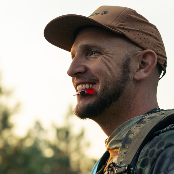 Elk hunter smiling while using Slayer's red Miner elk diaphragm in the field