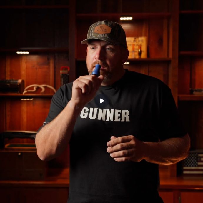 video of Eric Strand demonstrating the Bobby Guy + Slayer Calls collaboration call in a dark moody cabin.