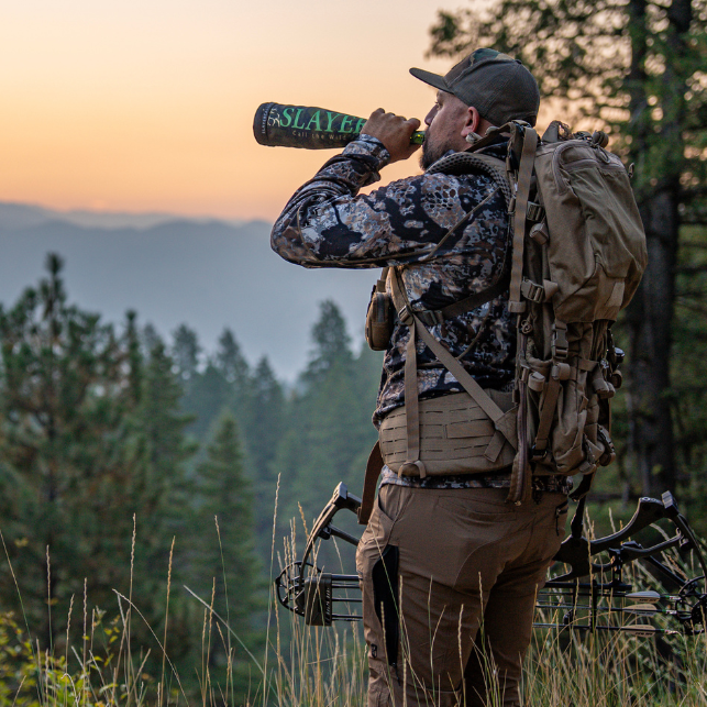 Elk hunter blowing the Slayer Guardian elk bugle in the elk woods.