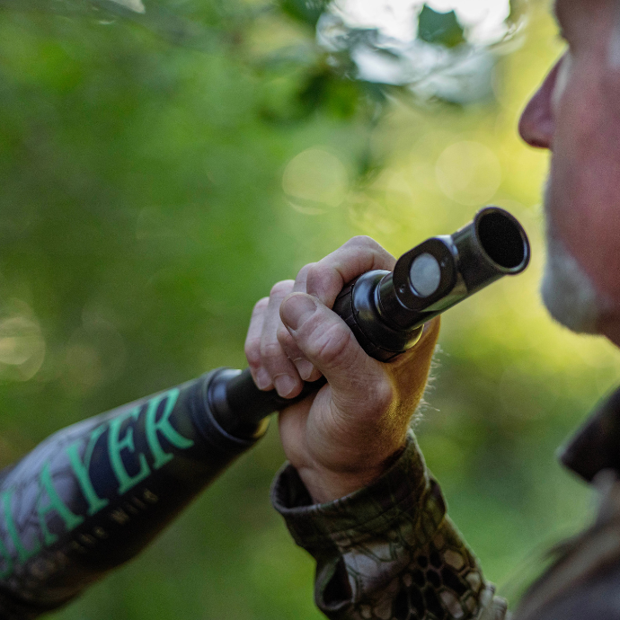 Elk hunter holding the Slayer's Enchanted Lil' Warrior push button elk call - bugle combo in the field.