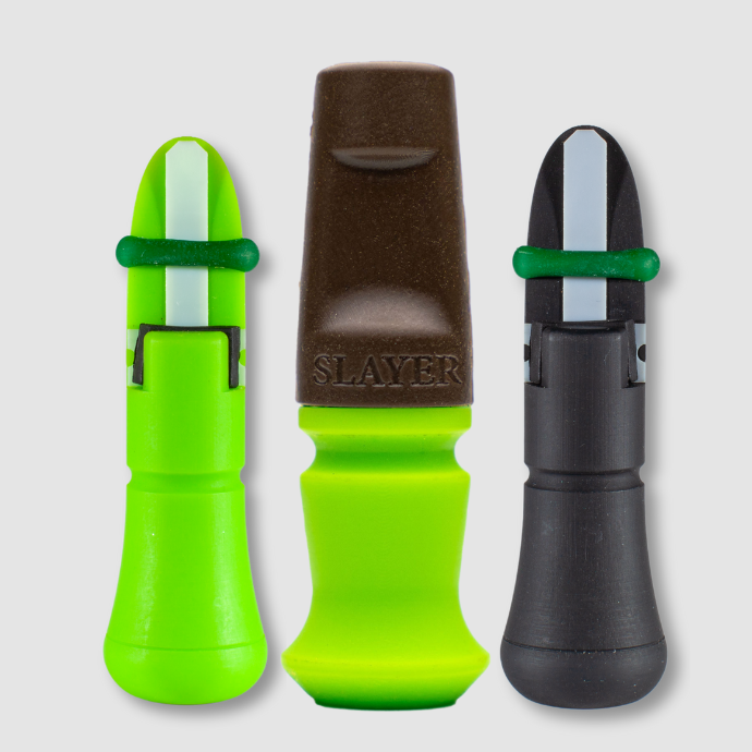 Three external elk calls by Slayer Calls, including green and brown Harem bite call, green calf call and black cow call.