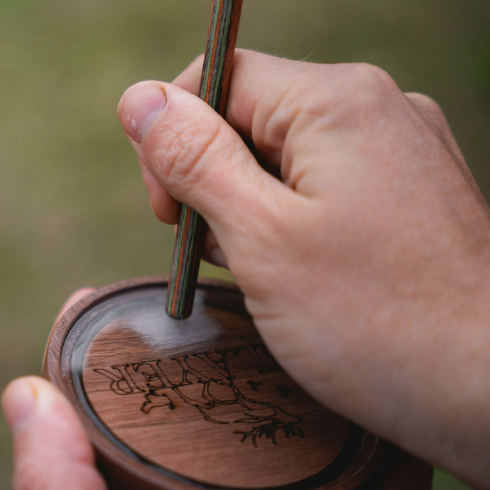Hunter using the Slayer Calls Crystal Queen turkey pot call with a composite striker for realistic hen sounds.