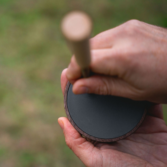 Close-up of Slayer Calls’ Seductive Hen slate turkey pot call in use, producing lifelike hen sounds with a wood striker