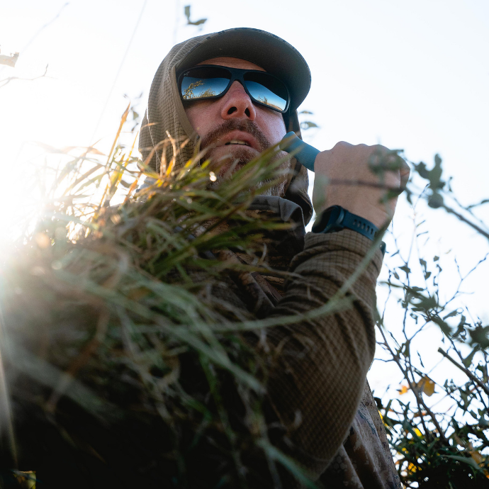 waterfowl hunter blowing the MC duck call