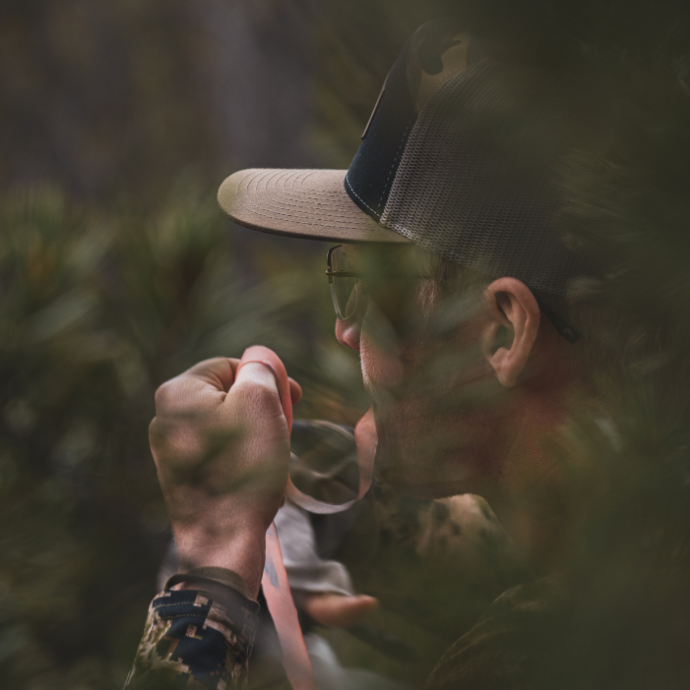 Close up of elk hunter using Slayer Calls' Clearwater Series elk reeds in the field.