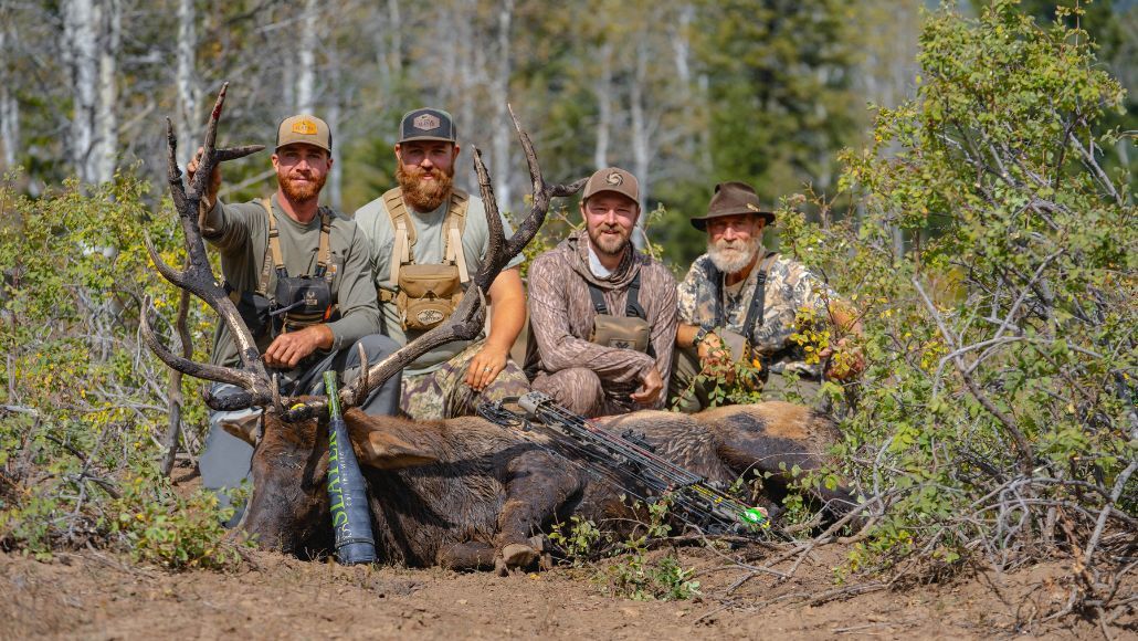 Elk hunters with bull down and Slayer's Archangel elk bugle