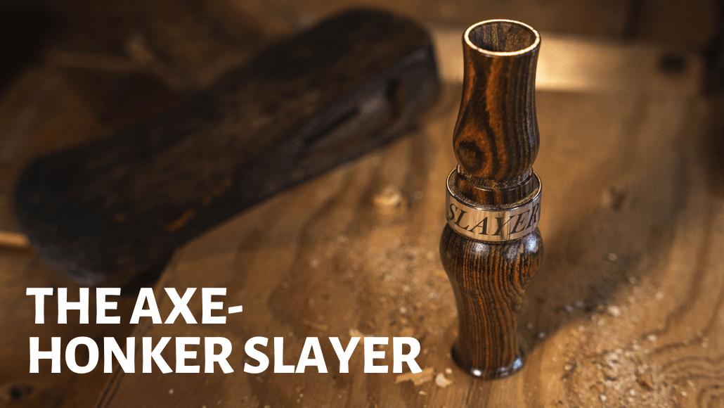 The Axe wood goose call on stump with axe