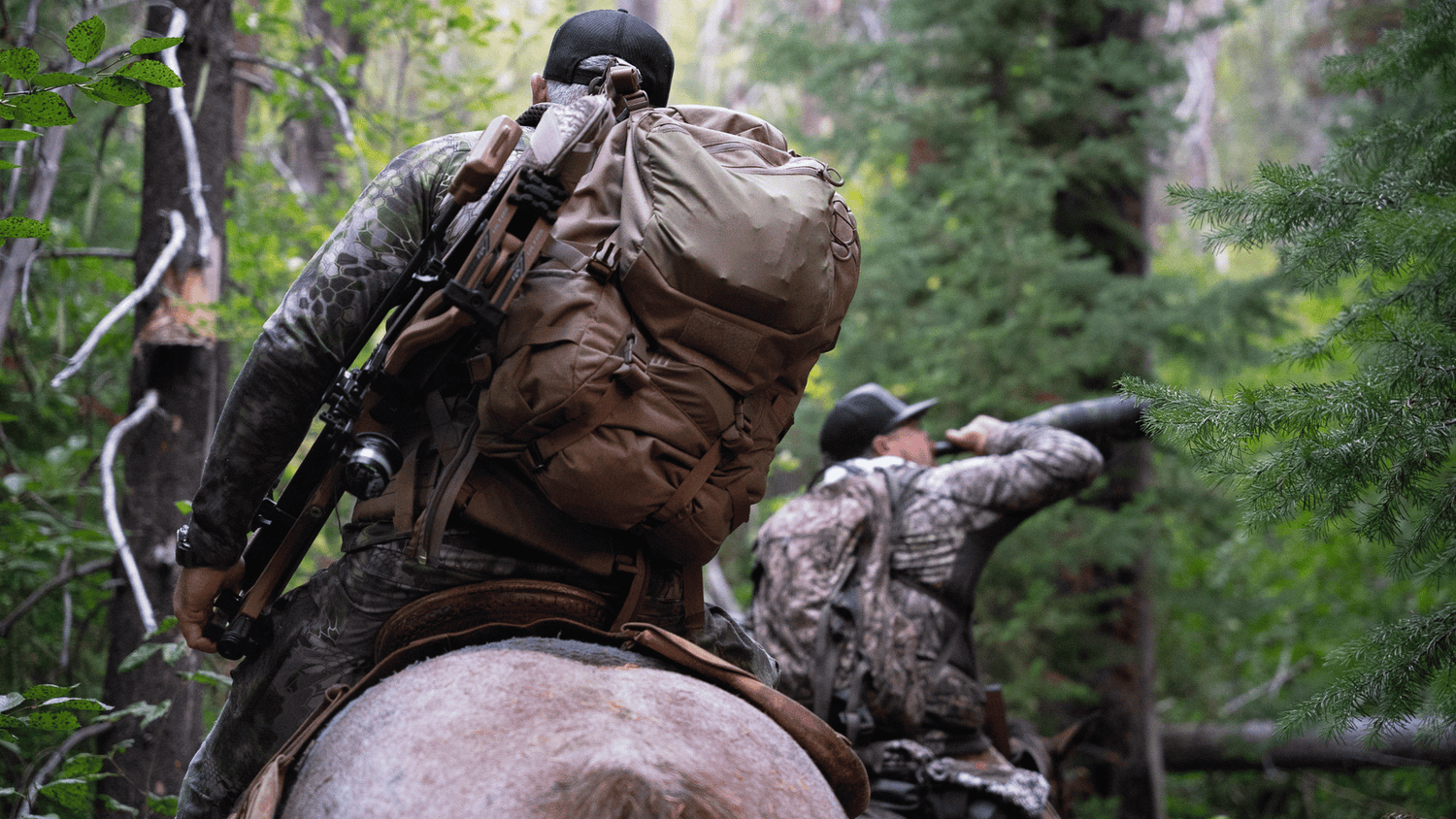 Archery elk hunter on horseback in the mountains of British Columbia, Canada.