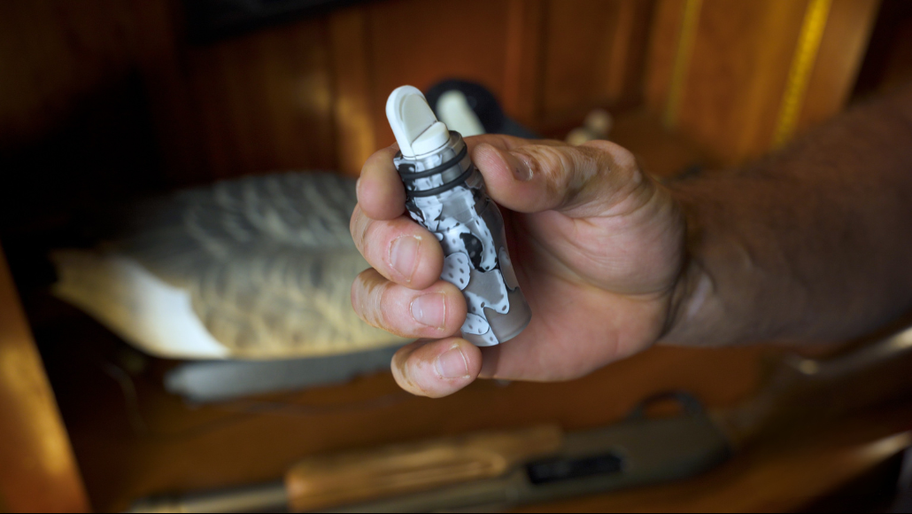 Waterfowl hunter  holding a Honker Slayer goose call by Slayer Calls in his hand demonstrating how to tune a goose call.