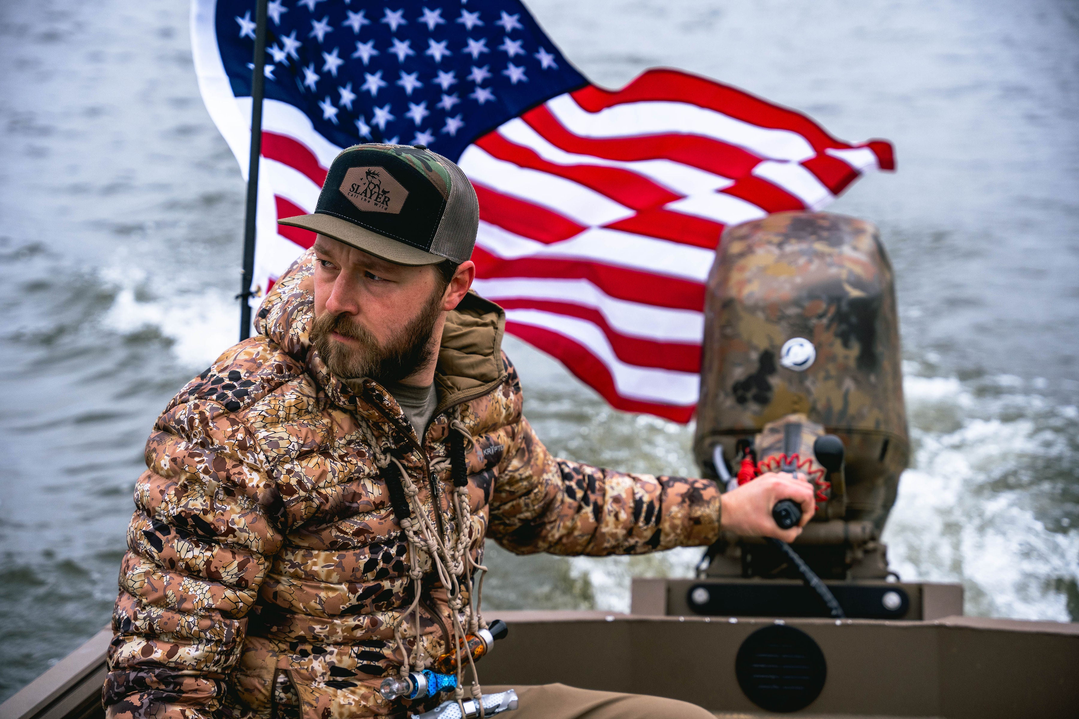 Hunter on boat in front of an american flag