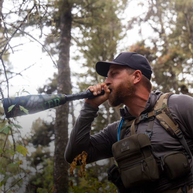 A Slayer PRO elk hunter using the Enchanted Lil' Warrior to bugle with—a push button elk call system that attaches to the compact Lil' Warrior elk bugle tube.