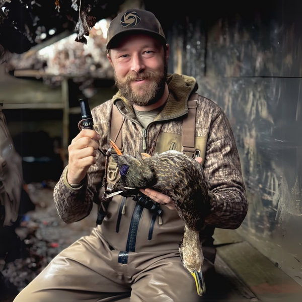 Hunter with call and dead duck