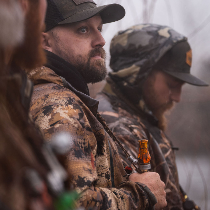 Hunter blowing the drake slayer single reed duck call in black death color