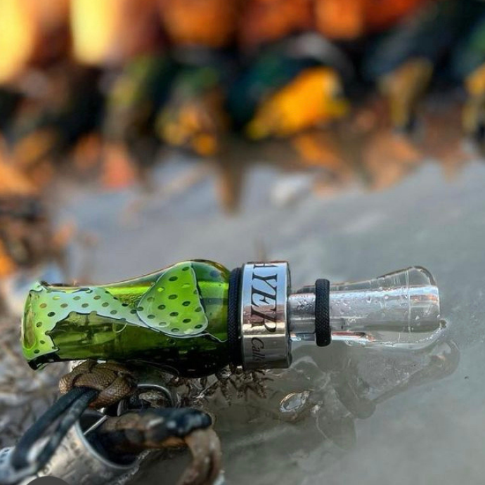 Hunter blowing the drake slayer single reed duck call in black death color