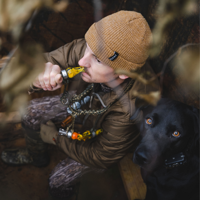 Hunter blowing the drake slayer single reed duck call in black death color
