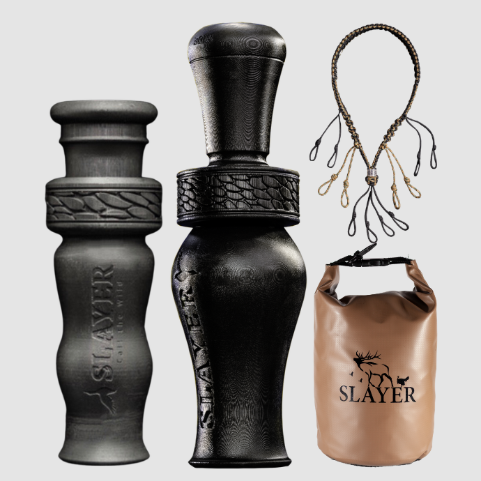 Black duck call with 'Slayer' branding, a dry bag, a duck whistle, and a waterfowl lanyard on a light gray background.