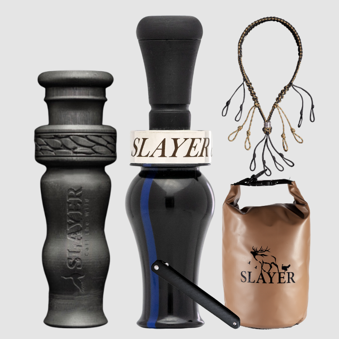 Slayer Calls duck call and duck whistle collection with Slayer's DUBAR Slayer duck call in deep blue with a "thin blue line", 4-in-1 duck whistle, lanyard, field dressing tool, and dry bag featuring SLAYER logo. 