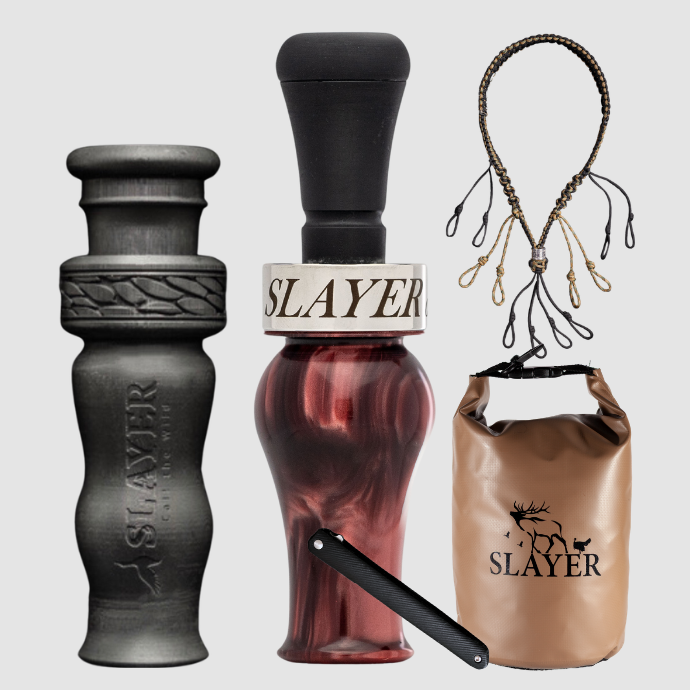 Slayer Calls duck call and duck whistle collection with Slayer's DUBAR Slayer duck call in garnet, 4-in-1 duck whistle, lanyard, field dressing tool, and dry bag featuring SLAYER logo. 