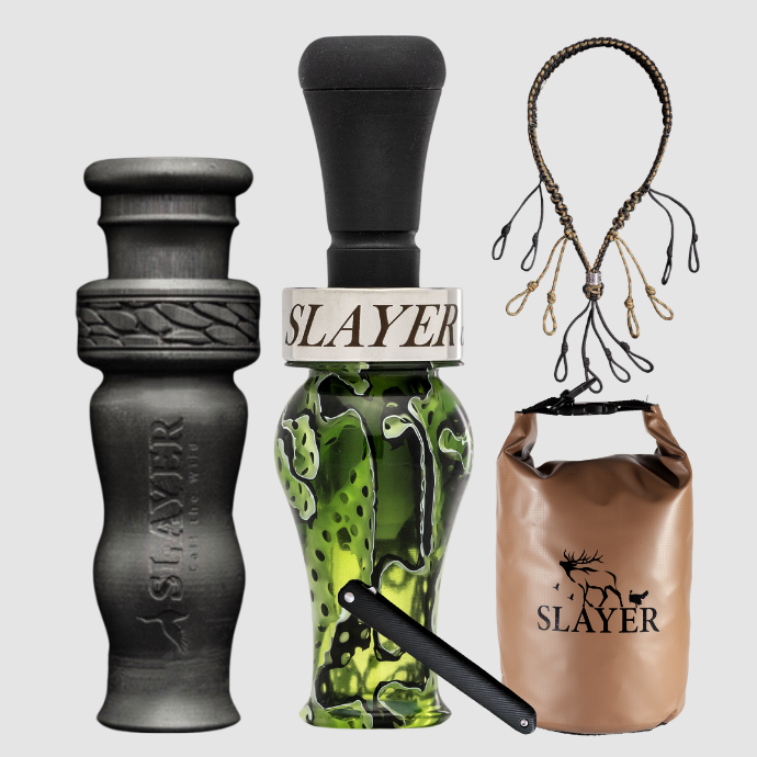 Slayer Calls duck call and duck whistle collection with Slayer's DUBAR Slayer duck call in green, 4-in-1 duck whistle, lanyard, field dressing tool, and dry bag featuring SLAYER logo. 
