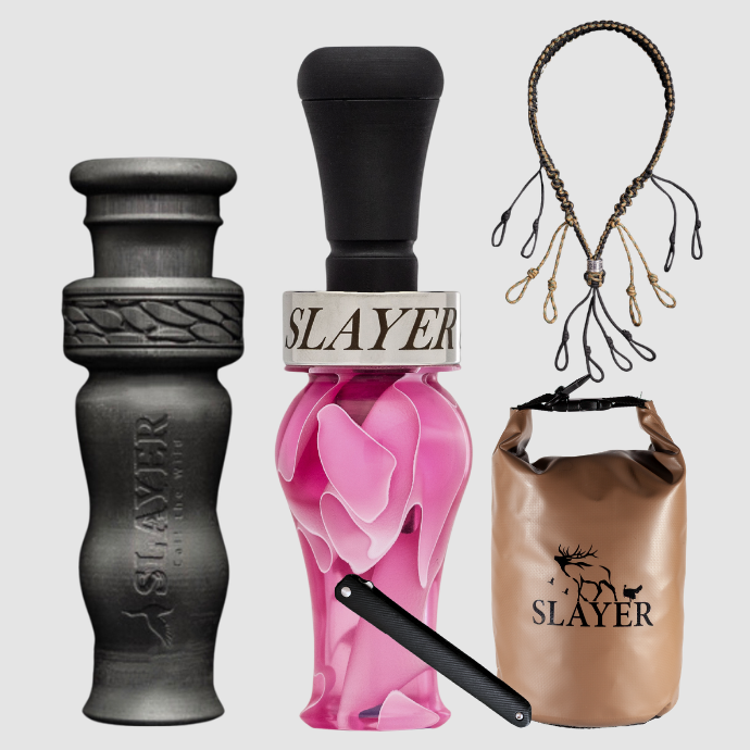 Slayer Calls duck call and duck whistle collection with Slayer's DUBAR Slayer duck call in pink acrylic, 4-in-1 duck whistle, lanyard, field dressing tool, and dry bag featuring SLAYER logo. 