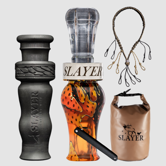 Collection of Slayer duck calls, lanyard and field bag on a light grey background