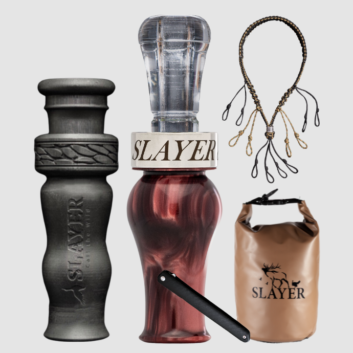 Slayer Calls duck call and duck whistle bundle with Slayer's double reed Drake Slayer duck call in garnet, 4-in-1 duck whistle, lanyard, field dressing tool, and dry bag featuring SLAYER logo. 