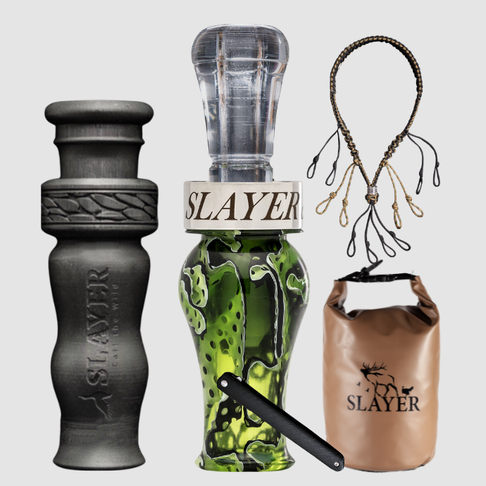 Collection of Slayer duck calls, lanyard and field bag on a light grey background