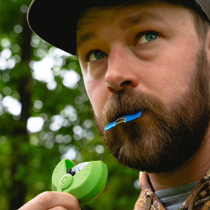 Close up of elk hunter using the Selway elk reed from the Clearwater Series, shown with Slayer green  Reed Pack'r.